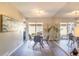 Bright dining area with modern table and chairs, sliding glass door, and decorative mirror wall at 3512 S Kittredge St # C, Aurora, CO 80013