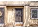 Inviting entrance with a decorative door, a welcome mat, and natural stone landscaping at 3512 S Kittredge St # C, Aurora, CO 80013