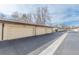 Row of attached garages at a condominium complex with paved parking and neutral paint at 3512 S Kittredge St # C, Aurora, CO 80013