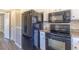 Modern kitchen includes a black refrigerator, oven and microwave providing functionality and style at 3512 S Kittredge St # C, Aurora, CO 80013