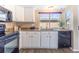 Bright kitchen offers white cabinetry, granite countertops, and modern black appliances at 3512 S Kittredge St # C, Aurora, CO 80013