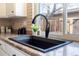 Modern kitchen sink features sleek design, granite countertop, and a window that bring natural light at 3512 S Kittredge St # C, Aurora, CO 80013