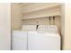 Functional laundry room equipped with a washer, dryer, and shelving for streamlined organization at 3512 S Kittredge St # C, Aurora, CO 80013