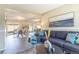 Open-concept living area with a large mirror, a stylish sofa, and a view into the dining space at 3512 S Kittredge St # C, Aurora, CO 80013