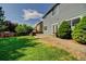 Landscaped backyard features a stone patio and green lawn, perfect for outdoor entertaining at 8416 S Reed St, Littleton, CO 80128