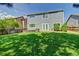 Backyard with manicured lawn, stone patio and well-maintained landscaping for outdoor enjoyment at 8416 S Reed St, Littleton, CO 80128