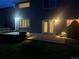 Backyard at night featuring a patio and outdoor lighting, perfect for entertaining at 8416 S Reed St, Littleton, CO 80128