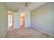 Bedroom with doors to other rooms and closet at 8416 S Reed St, Littleton, CO 80128