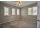 Bedroom with carpet, ceiling fan and natural light from shuttered windows at 8416 S Reed St, Littleton, CO 80128