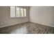 Bright bedroom with hardwood floors, ample natural light, and neutral color palette at 8416 S Reed St, Littleton, CO 80128