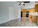 Bright kitchen features wood cabinets, black appliances, and durable gray wood-look flooring at 8416 S Reed St, Littleton, CO 80128