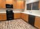 Bright kitchen features wood cabinets, black appliances and hard surface countertops at 8416 S Reed St, Littleton, CO 80128