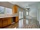 Kitchen area has wood cabinets, lots of light, and views to dining and living area at 8416 S Reed St, Littleton, CO 80128
