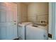 Laundry area with washer, dryer, and close proximity to exterior door at 8416 S Reed St, Littleton, CO 80128