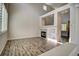 Open living room with a fireplace, hardwood floors, and open sightlines into the next room at 8416 S Reed St, Littleton, CO 80128