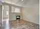 Cozy living room with a fireplace and hardwood floors, with an open view into the next room at 8416 S Reed St, Littleton, CO 80128