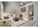 Inviting living room featuring a fireplace, modern decor, and plenty of natural light at 8416 S Reed St, Littleton, CO 80128