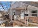 Inviting front porch with a rocking chair and decorative stonework at 3280 S Downing St, Englewood, CO 80113