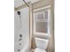 Bathroom featuring a tub with a shower head and a toilet by a window at 3522 Harvard Pl, Broomfield, CO 80023
