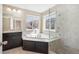 Bathroom featuring a soaking tub, glass shower, and windows for natural light at 3522 Harvard Pl, Broomfield, CO 80023