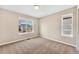 The carpeted bedroom features neutral walls and a large window that overlooks the property's surrounding neighborhood at 3522 Harvard Pl, Broomfield, CO 80023