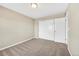 This bedroom features neutral walls, soft carpet, and a closet with white sliding doors at 3522 Harvard Pl, Broomfield, CO 80023