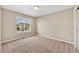 This bedroom features neutral walls, carpeted floor, and a window with a view of the neighborhood at 3522 Harvard Pl, Broomfield, CO 80023