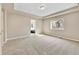 A spacious bedroom features plush carpeting and a large window offering a pleasant view of the neighborhood at 3522 Harvard Pl, Broomfield, CO 80023