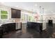 Stylish kitchen with dark cabinets, a spacious island, and stainless steel appliances, open to a dining area at 3522 Harvard Pl, Broomfield, CO 80023