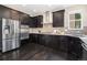 Well-appointed kitchen with dark wood cabinets, stainless steel appliances, and granite countertops at 3522 Harvard Pl, Broomfield, CO 80023
