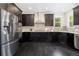 Well-appointed kitchen with dark wood cabinets, stainless steel appliances, and granite countertops at 3522 Harvard Pl, Broomfield, CO 80023