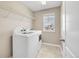 Laundry room features newer washer, dryer, overhead shelving, and a window for natural light at 3522 Harvard Pl, Broomfield, CO 80023