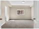A spacious main bedroom features plush carpeting, a tray ceiling, and a large window with a neighborhood view at 3522 Harvard Pl, Broomfield, CO 80023