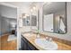 Bathroom features double sinks with stone countertops, framed mirrors, and a shower at 1544 E Weldona Way, Superior, CO 80027