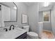 Well-lit bathroom featuring a modern sink, toilet, and convenient laundry area with a washing machine at 1544 E Weldona Way, Superior, CO 80027