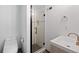 Modern bathroom with sleek white fixtures, a glass-enclosed shower, and a minimalist design for a clean aesthetic at 1544 E Weldona Way, Superior, CO 80027
