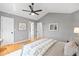 Large bedroom includes hardwood flooring, neutral walls, ceiling fan, and generous closet space at 1544 E Weldona Way, Superior, CO 80027