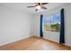 Bedroom with hardwood flooring features a large window with scenic views and a ceiling fan at 1544 E Weldona Way, Superior, CO 80027