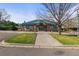 Community clubhouse with a well-maintained exterior, set amidst lush greenery and a paved pathway at 1544 E Weldona Way, Superior, CO 80027