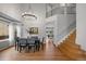 Bright dining space featuring hardwood floors, a statement chandelier, and a view of the second story at 1544 E Weldona Way, Superior, CO 80027