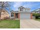 Charming two-story home with a well-manicured lawn, complemented by a two-car garage and tasteful brick accents at 1544 E Weldona Way, Superior, CO 80027