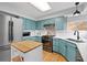 Well-lit kitchen features modern appliances, blue cabinets, white countertops and backsplash at 1544 E Weldona Way, Superior, CO 80027