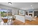 Open living room and dining area features hardwood floors and sliding door access to the outside deck at 1544 E Weldona Way, Superior, CO 80027