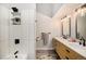 Contemporary bathroom with dual sinks, wooden cabinets, modern fixtures, and a tiled shower at 2279 E 129Th Ave, Thornton, CO 80241