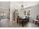 Bright dining room with a modern chandelier, large window, and hardwood floors for Gathering meals at 2279 E 129Th Ave, Thornton, CO 80241