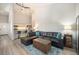 Stylish living room with high ceilings, a large black leather sofa, and open access to the kitchen at 2279 E 129Th Ave, Thornton, CO 80241