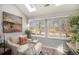 Cozy sunroom with large windows, a comfortable chaise lounge, and natural light perfect for relaxation at 2279 E 129Th Ave, Thornton, CO 80241
