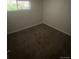 Bedroom with plush carpeting and natural light from a window, creating a cozy and inviting space at 8220 E 104Th Way, Henderson, CO 80640