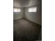 Bedroom with plush carpeting and ample natural light from two windows, creating a relaxing space at 8220 E 104Th Way, Henderson, CO 80640