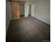 Bedroom with plush carpeting, closet with wooden sliding barn door and a minimalist design, cozy retreat at 8220 E 104Th Way, Henderson, CO 80640